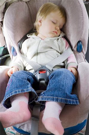 fastof (artist) - The small child fastened by seat belts sleeps in a carseat Stock Photo - Budget Royalty-Free & Subscription, Code: 400-04741700