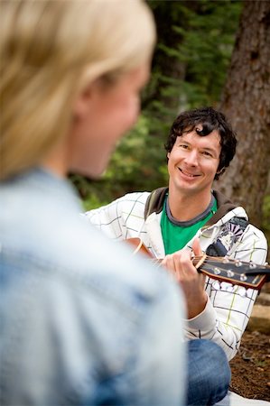 simsearch:6109-06003907,k - A man and woman in a forest with a guitar Stock Photo - Budget Royalty-Free & Subscription, Code: 400-04741896