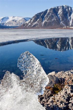 Big piece of ice on coast of lake in mountains Stockbilder - Microstock & Abonnement, Bildnummer: 400-04742901