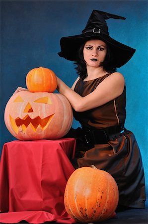 simsearch:400-08528806,k - Young witch with a pumpkin on a blue  background Photographie de stock - Aubaine LD & Abonnement, Code: 400-04743865