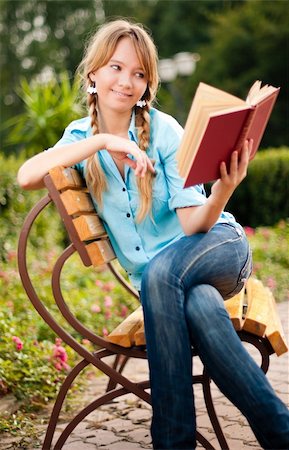 beautiful young student girl sitting on bench in campus park, reading book and smiling Fotografie stock - Microstock e Abbonamento, Codice: 400-04743965