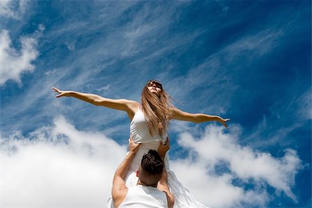 young couple dancing on sky background, freedom and relax symbol Stock Photo - Budget Royalty-Free & Subscription, Code: 400-04754008
