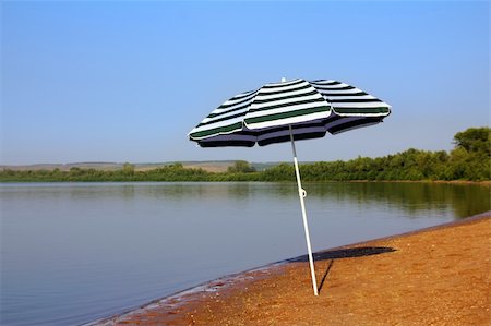 simsearch:400-09237669,k - sun umbrella on empty sandy river beach Stock Photo - Budget Royalty-Free & Subscription, Code: 400-04754694