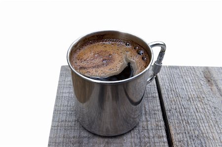 Metal mug of coffee on the wooden table. Isolated on white background. Stock Photo - Budget Royalty-Free & Subscription, Code: 400-04754856