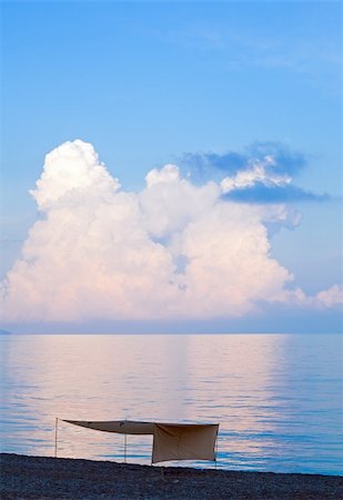 simsearch:400-09011314,k - Beautiful sunset in soft pink-blue colors, shining sea surface and sunshade on beach (Crimea, Ukraine). Stockbilder - Microstock & Abonnement, Bildnummer: 400-04755159