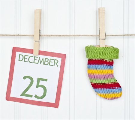 simsearch:400-04758693,k - Holiday Stocking or Sock on a Clothesline with a Christmas Calendar Page. Photographie de stock - Aubaine LD & Abonnement, Code: 400-04755475