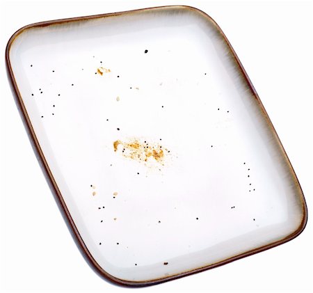 Empty Plate with Crumbs Isolated on White with a Clipping Path. Stock Photo - Budget Royalty-Free & Subscription, Code: 400-04755519