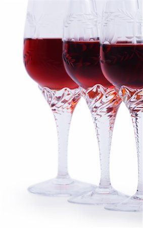 Three glasses of red wine isolated on a white background Focus is on the third glass. Hand made clipping path inside Foto de stock - Royalty-Free Super Valor e Assinatura, Número: 400-04756443