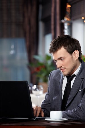 simsearch:400-04322314,k - Business man with the laptop sits at a table in cafe Stock Photo - Budget Royalty-Free & Subscription, Code: 400-04756707