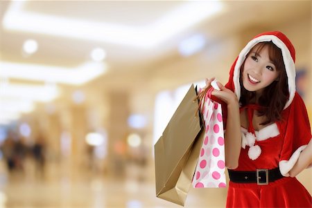 elwynn (artist) - Happy shopping girl wearing Christmas clothes holding bags in department store. Stock Photo - Budget Royalty-Free & Subscription, Code: 400-04756789