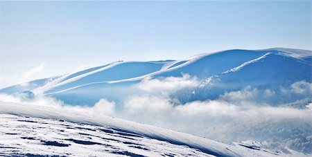 simsearch:400-05139590,k - Panoramic view of snowy mountain ridges emerging from clouds Foto de stock - Super Valor sin royalties y Suscripción, Código: 400-04757141