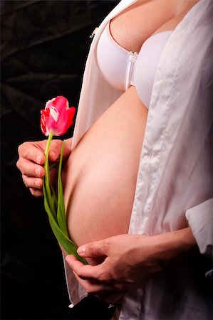 pregnant woman breast - Pregnant woman holding red tulip flower. Stock Photo - Budget Royalty-Free & Subscription, Code: 400-04757551