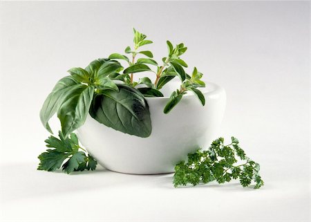 a variety of herbs arranged in a white bowl; white background Stock Photo - Budget Royalty-Free & Subscription, Code: 400-04757977