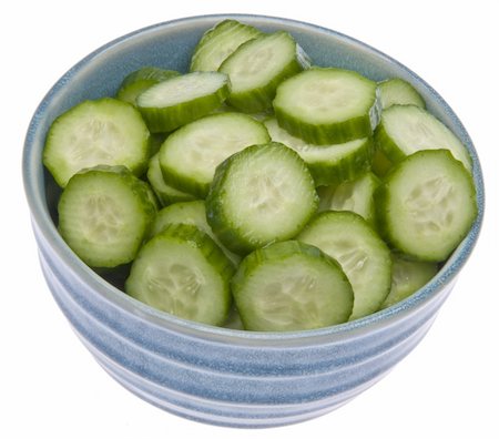 simsearch:400-07916427,k - Fresh blue bowl of sliced cucumbers isolated on white with a clipping path. Foto de stock - Super Valor sin royalties y Suscripción, Código: 400-04758358