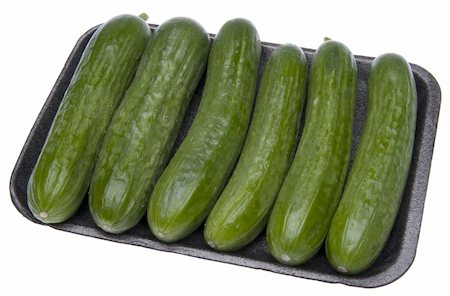 Six fresh cucumbers in grocery store packaging isolated on white with a clipping path. Stock Photo - Budget Royalty-Free & Subscription, Code: 400-04758593