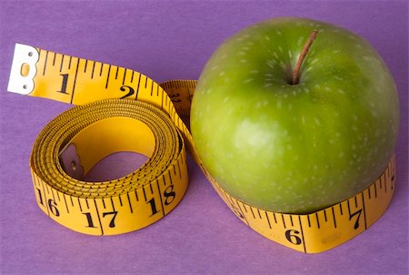 simsearch:400-04758612,k - Granny Smith Green Apple with a bright yellow tape measure represents the concepts of diet and healthy lifestyle. Perhaps this is your New Year's Resolution? Stock Photo - Budget Royalty-Free & Subscription, Code: 400-04758607