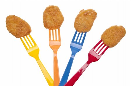 simsearch:400-05308926,k - Kid Friendly Chicken Nuggets on Bright Plastic Forks for a Fun Snack. Photographie de stock - Aubaine LD & Abonnement, Code: 400-04759134