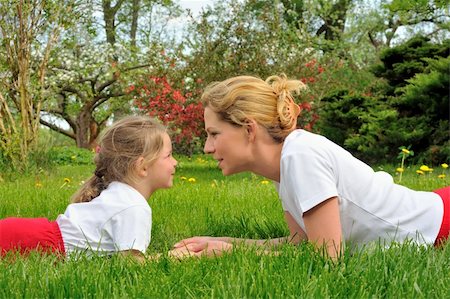 simsearch:400-04795754,k - Young mother and daughter laying on the grass Stock Photo - Budget Royalty-Free & Subscription, Code: 400-04750089