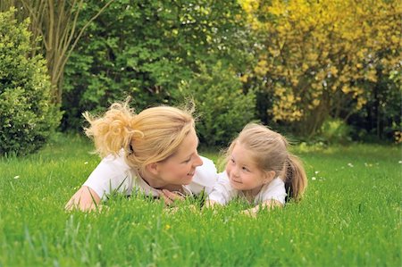 simsearch:400-04795754,k - Young mother and daughter laying on the grass Stock Photo - Budget Royalty-Free & Subscription, Code: 400-04750092