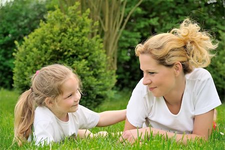 simsearch:400-04795754,k - Young mother and daughter laying on the grass Stock Photo - Budget Royalty-Free & Subscription, Code: 400-04750093