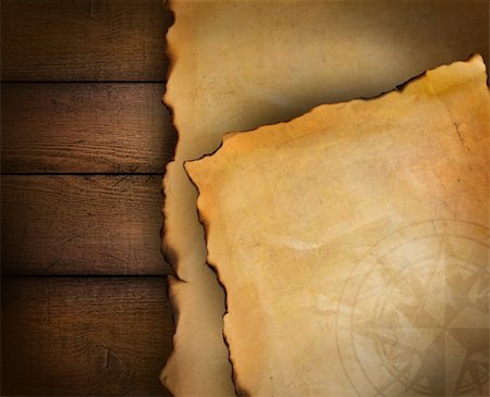 scrolled up paper - Closeup of parchment paper on wood background Stock Photo - Budget Royalty-Free & Subscription, Code: 400-04750681