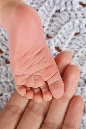 small soles - Foot of newborn baby resting on his mothers fingers Stock Photo - Budget Royalty-Free & Subscription, Code: 400-04751251