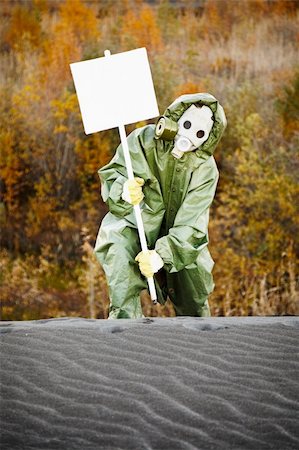 Scientist in protective suit and gas mask carry poster Stock Photo - Budget Royalty-Free & Subscription, Code: 400-04751658