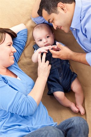 feverpitched (artist) - Mixed Race Family Playing Face Up on the Blanket. Foto de stock - Royalty-Free Super Valor e Assinatura, Número: 400-04751688