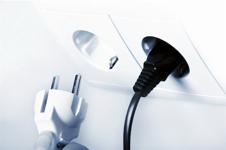 family electricity - A picture of socket and two black and white plugs over white background Stock Photo - Budget Royalty-Free & Subscription, Code: 400-04752070