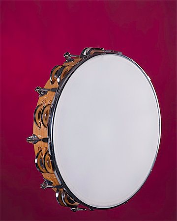 A wood frame tambourine isolated against a red background. Stock Photo - Budget Royalty-Free & Subscription, Code: 400-04752652