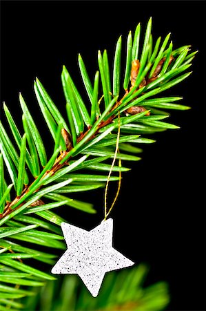Fir branch with hanging Christmas decorations on a black background. Photographie de stock - Aubaine LD & Abonnement, Code: 400-04752667