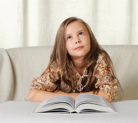 photography of little girl dreaming - Little girl dreams when reading the book Stock Photo - Budget Royalty-Free & Subscription, Code: 400-04753488