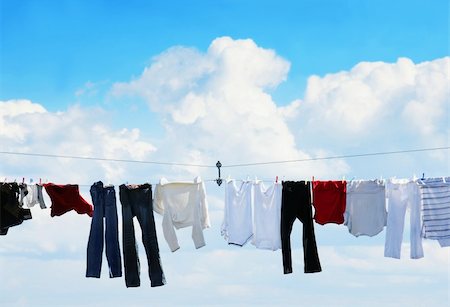 simsearch:400-04383276,k - Pants and shirts on clothesline against beautiful white puffy cloud on a sunny day. Stock Photo - Budget Royalty-Free & Subscription, Code: 400-04753663