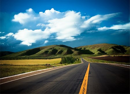 road to the future with the mountain and blue sky background outdoor. Stock Photo - Budget Royalty-Free & Subscription, Code: 400-04764306