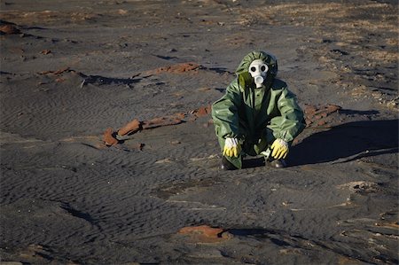 A man in protective clothing sitting in the desert Stock Photo - Budget Royalty-Free & Subscription, Code: 400-04764431