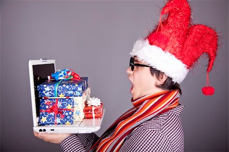 Funny men in christmas cap with gift boxes and notebook. Studio shot. Stock Photo - Budget Royalty-Free & Subscription, Code: 400-04764602