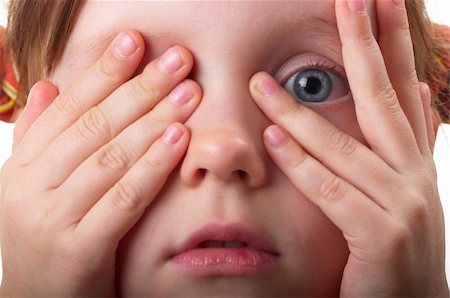 Little girl peeping through hand with one eye macro shot Fotografie stock - Microstock e Abbonamento, Codice: 400-04764978