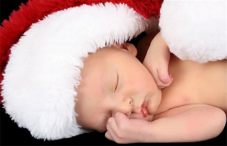 family relaxing at christmas - Beautiful Newborn christmas baby wearing a fluffy hat Stock Photo - Budget Royalty-Free & Subscription, Code: 400-04765209