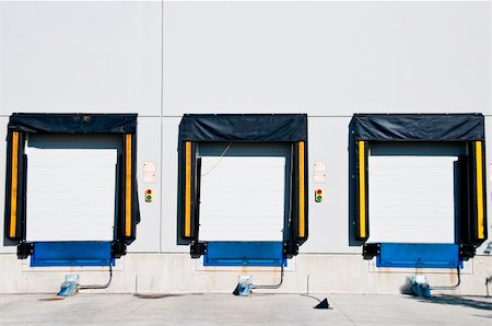 Three freight  loading doors with a set of green and red light to aid driver. Stock Photo - Budget Royalty-Free & Subscription, Code: 400-04765325