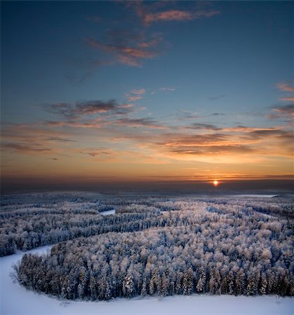 The Aerial view of snow-covered winter forest in time sundown on Christmas Eve. Stock Photo - Budget Royalty-Free & Subscription, Code: 400-04765848