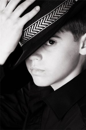 Teenage boy wearing a black hat in casual wear Stock Photo - Budget Royalty-Free & Subscription, Code: 400-04765992