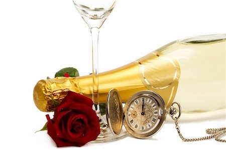 wet red rose under a champagne bottle with a old pocket watch and a empty champagne glass on white background Stock Photo - Budget Royalty-Free & Subscription, Code: 400-04766803