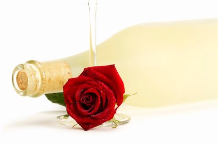 wet red rose with a empty champagne glass in front of a dull prosecco bottle on white background Stock Photo - Budget Royalty-Free & Subscription, Code: 400-04766822