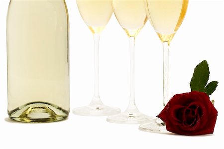 wet red rose in front the bottom from three champagne glasses and a champagne bottle on white background Stock Photo - Budget Royalty-Free & Subscription, Code: 400-04766823