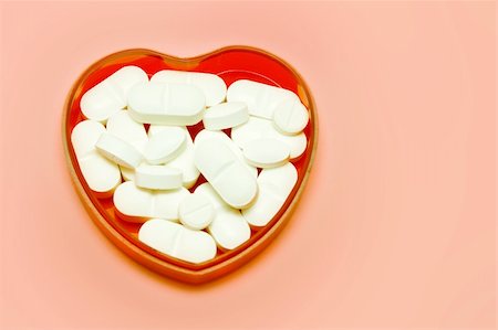 simsearch:400-08752895,k - plastic heart holding some pills over pink Stock Photo - Budget Royalty-Free & Subscription, Code: 400-04767485
