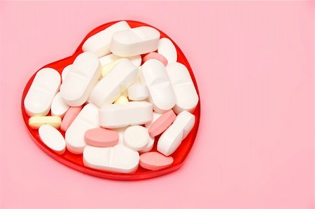 simsearch:400-08752895,k - plastic heart holding some pills over pink Stock Photo - Budget Royalty-Free & Subscription, Code: 400-04767487