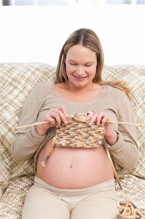 simsearch:400-04266869,k - Cute future mother knitting sitting on the sofa at home Stock Photo - Budget Royalty-Free & Subscription, Code: 400-04767803