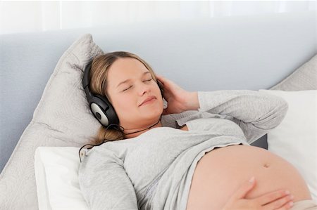 simsearch:400-04266869,k - Peaceful future mother with headphones on lying on a bed at home Stock Photo - Budget Royalty-Free & Subscription, Code: 400-04767852