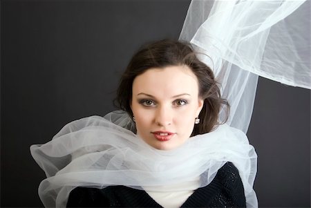 smiling in the wind with scarf - Portrait of a young seductive brunette over black Stock Photo - Budget Royalty-Free & Subscription, Code: 400-04768323