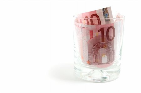 Some euro banknotes in a tumbler isolated on white background Stock Photo - Budget Royalty-Free & Subscription, Code: 400-04768480